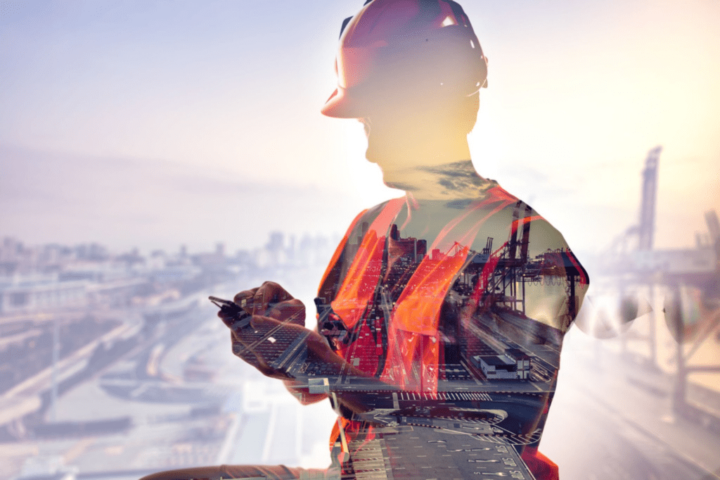 A double exposure of a construction worker and the city.