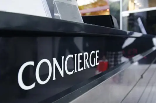 A concierge sign on the side of a car.