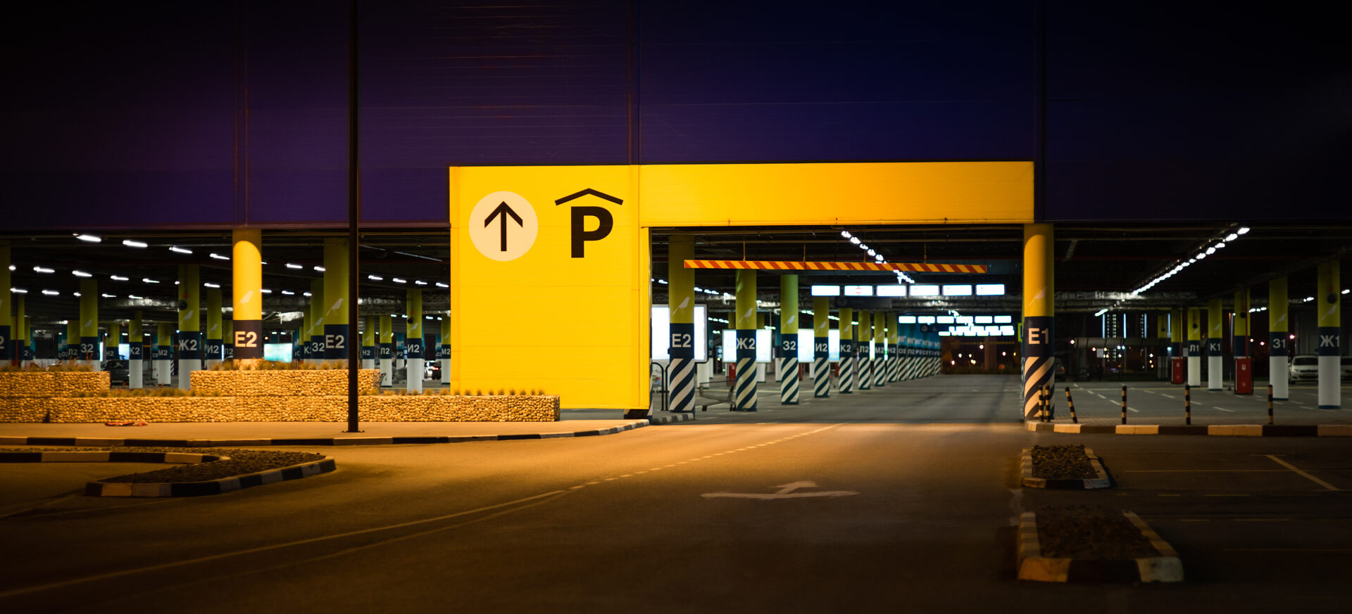A parking lot with a yellow sign and an arrow pointing up.